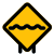 Rough road ahead with multiple bumps traffic board icon